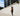 Person running on a sidewalk with tall buildings in the background